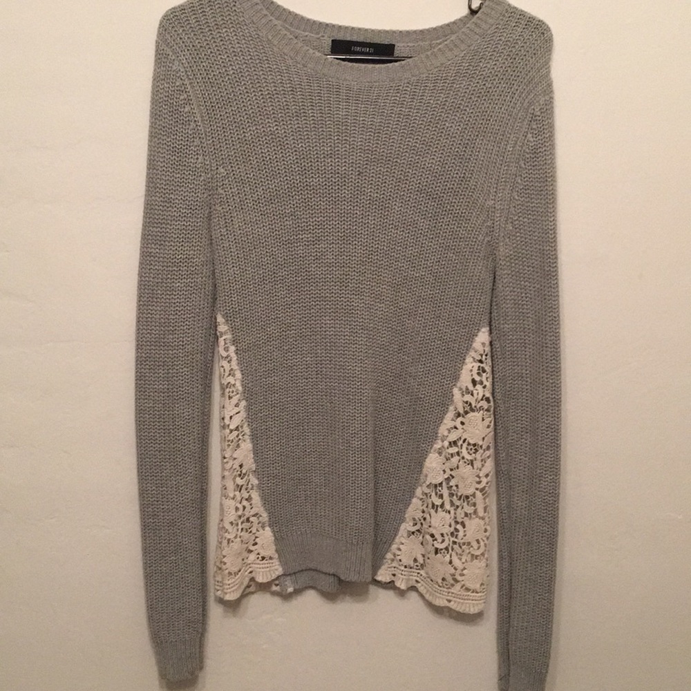 Grey knit sweater with cream crochet side panels